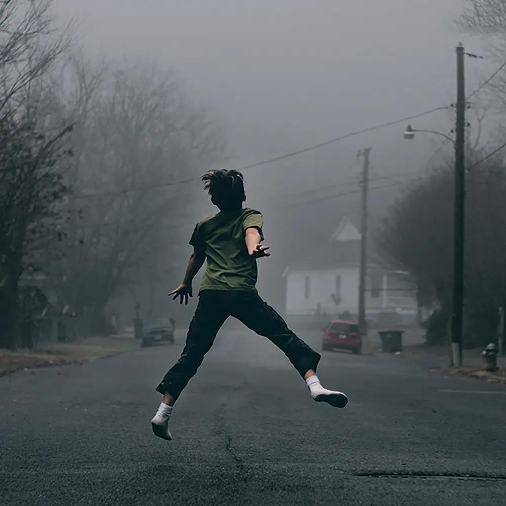Artist jumping in the street